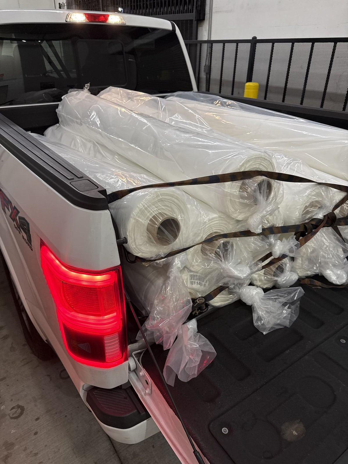 Rolls of fabric secured in the bed of a pickup truck